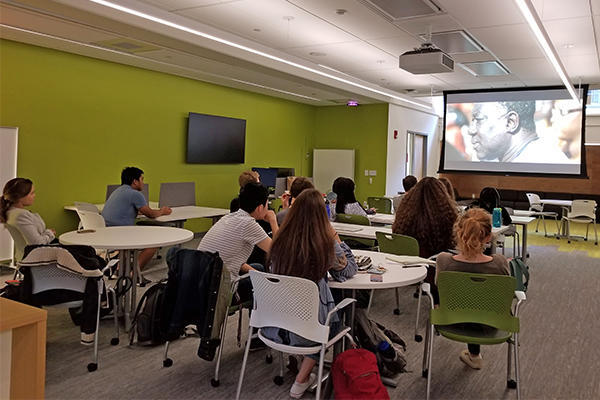 Harvard Language Center students and tables watching a film