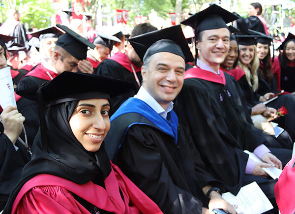 students and faculty at graduation