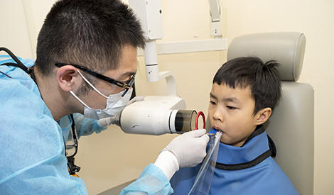 child having teeth xrayed by dentist