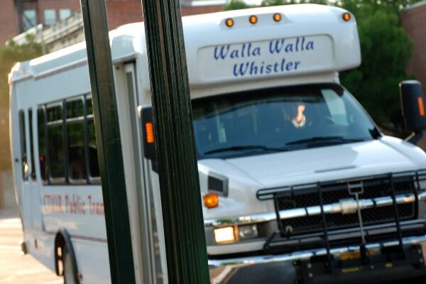 Small twenty-something seat bus with front sign that says "Walla Walla Whistler".