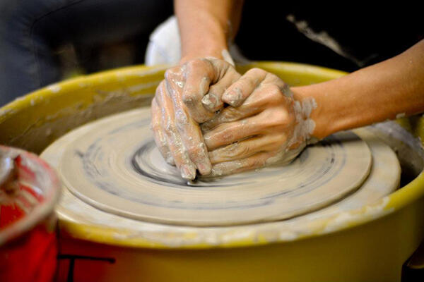 Hands on a pottery wheel