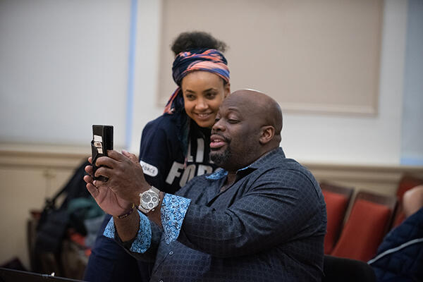 Morris Robinson takes a photo with a student