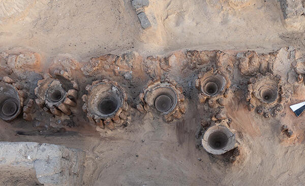 Bird's eye view of an archaeological dig with broken vases.