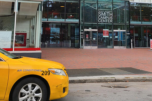 A yellow taxi outside of the entrance to the Smith Campus Center