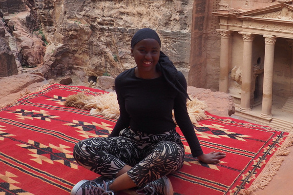 student abroad, sitting on a rug