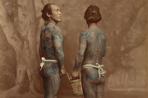 two men shown with tattoos.