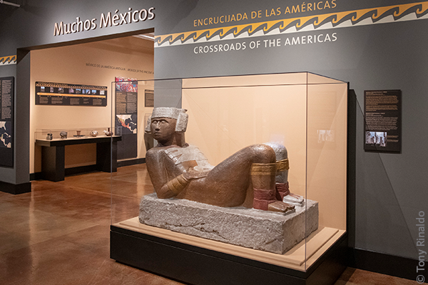 threshold of muchos mexicos exhibit with reclining statue.