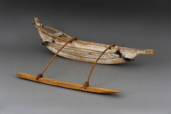 model of canoe with outrigger.