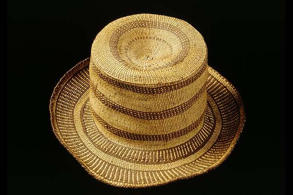A woven fiber hat resembling a top hat.