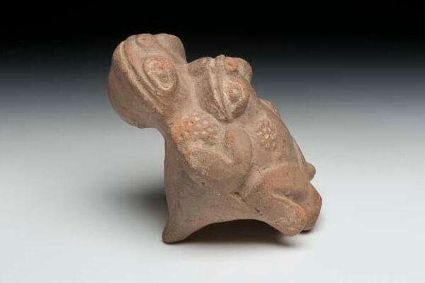 Ceramic frog effigy whistle, molded and punctated features, dual chambers and mouthpieces.