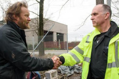 Firefighter and man shaking hands