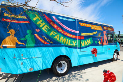 A mobile health clinic called the Family Van outside on a sunny day