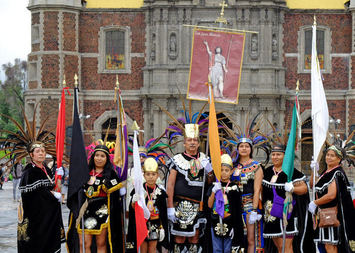 Worshipers in traditional dress hold a banner for St. John the Divine, Shrine of the Virgin of Guadalupe