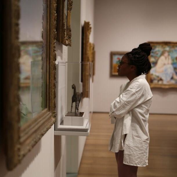 Student inspecting art at Harvard's Fogg Museum