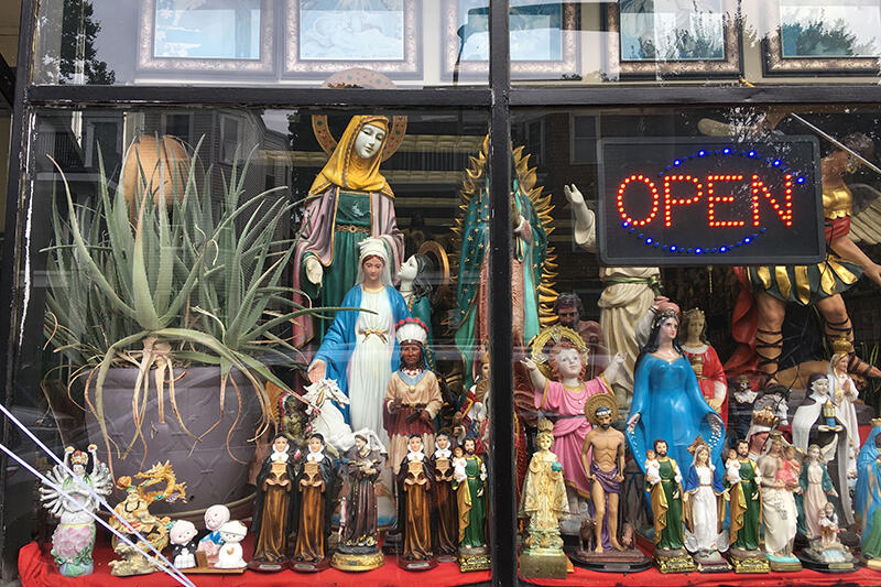 Store display window with Christian religious figurines