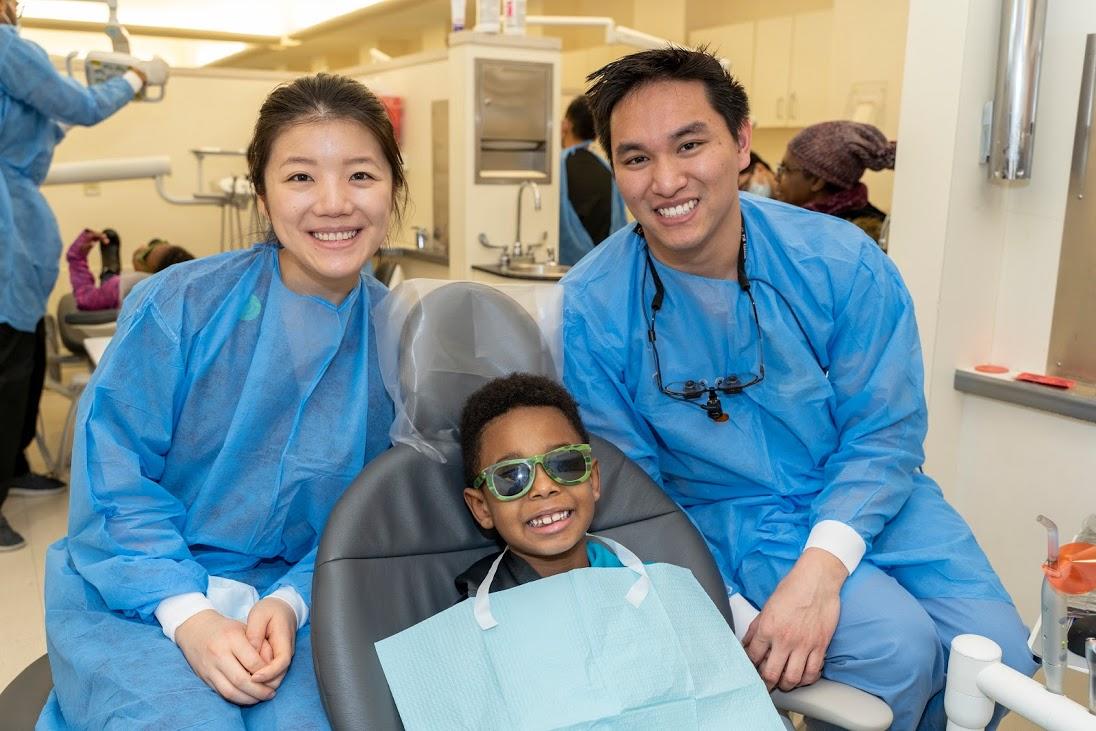 HSDM students administer care to a pediatric patient on Give Kids a Smile Day 2019