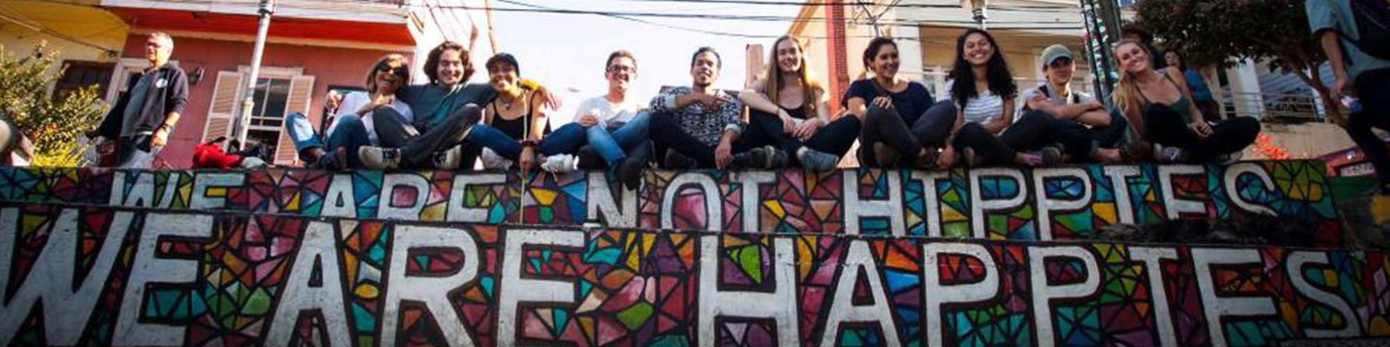 students sitting on a mural in Chile