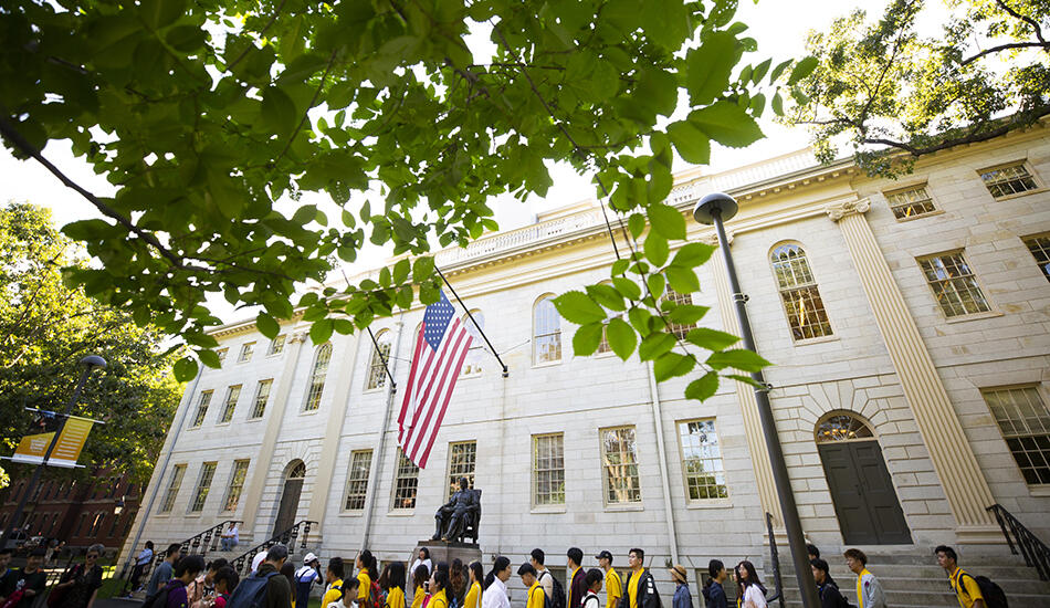 University Hall with tourists around the John Harvard statue