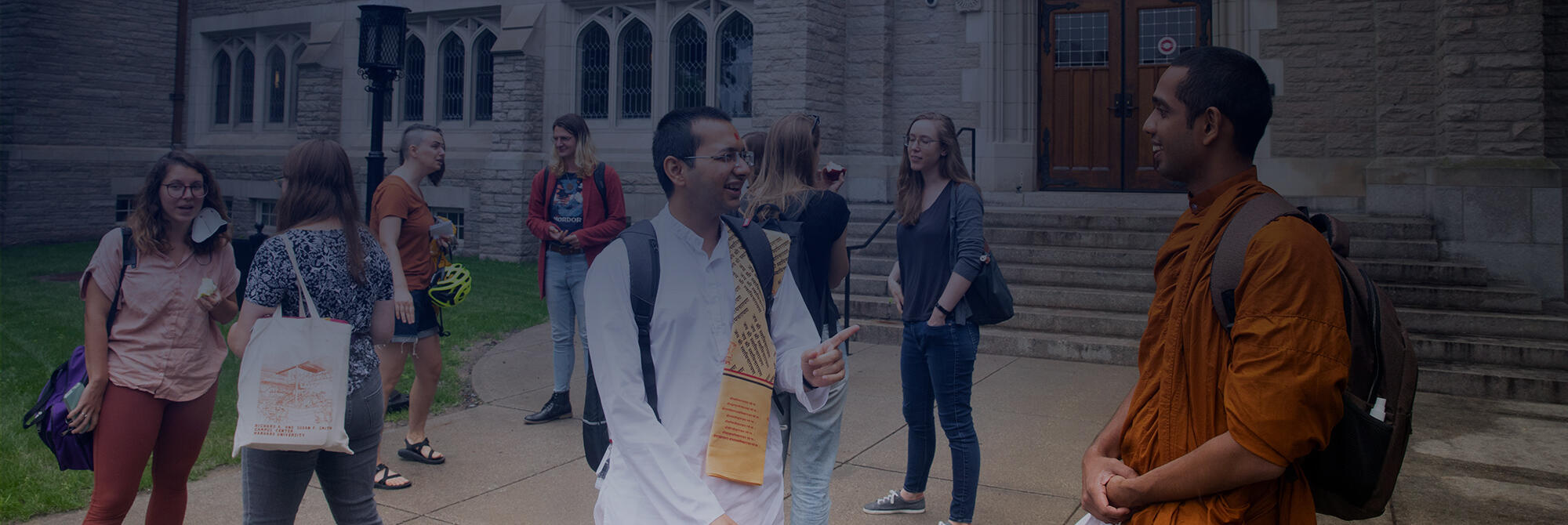 HDS students talking outside Swartz Hall, including Hindu and Buddhist monks