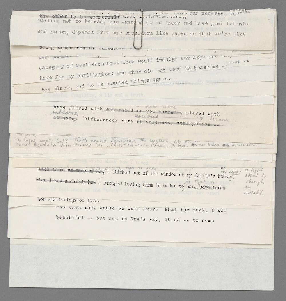 Strips of paper containing phrases from previous drafts, clipped together.