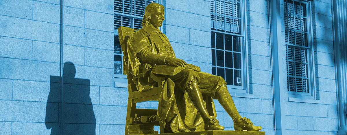 John Harvard statue colored blue and yellow