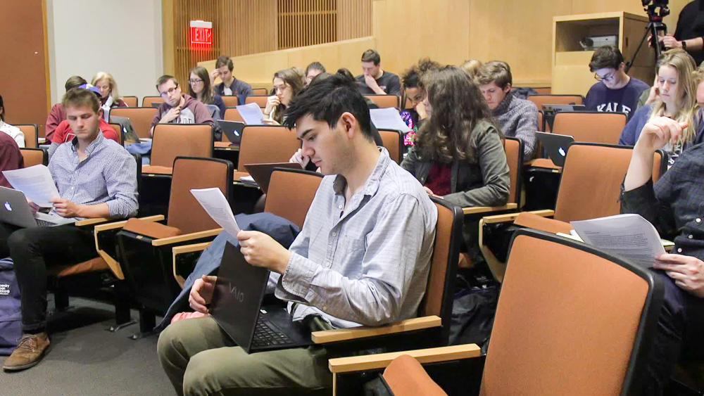 Students studying a handout