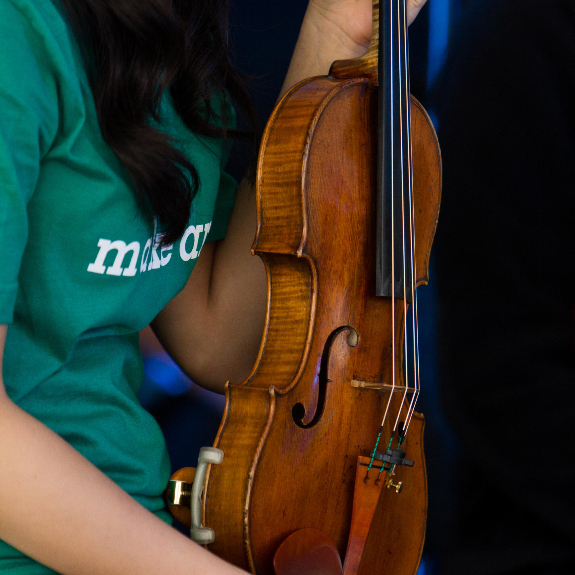 Detail photo of a student holding a violin