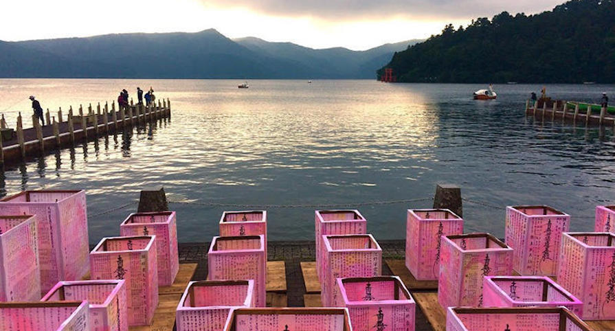 lake in japan, bright pink containers on the deck