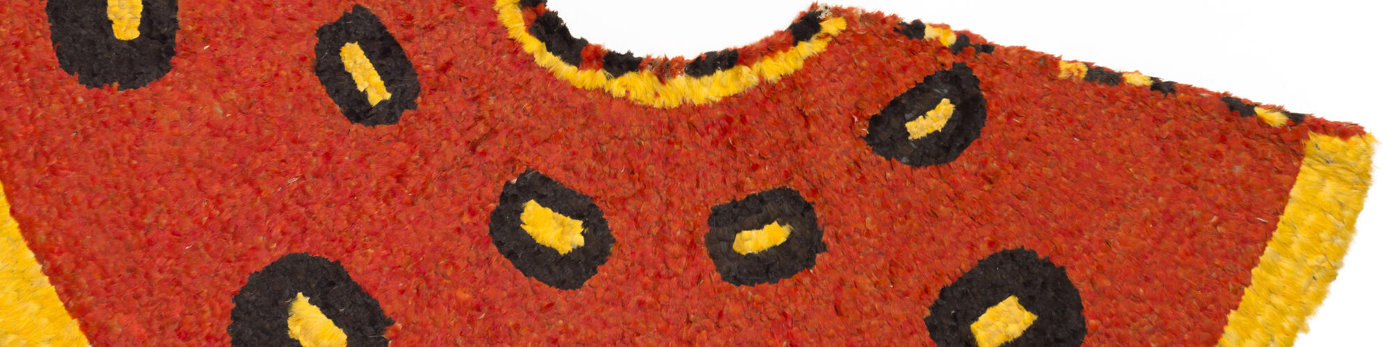Red, yellow and black feathered cape from Hawaii