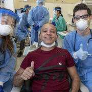dental students with veteran patient giving thumbs up