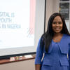 Uche Pedro smiling as she presents her work at the Ash Center
