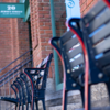 Blue and red stadium chairs line the street outside of the 20 Jersey Street Entrance to Fenway Park