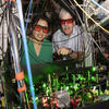 Kang-Kuen Ni and John Doyle stand in their lab surrounded by wires and lasers
