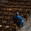 A man sits alone in a church sanctuary during the early days of the Coronavirus outbreak. / Photo: Catholic Church of England and Wales