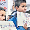 Children holding signs against Islamophobia